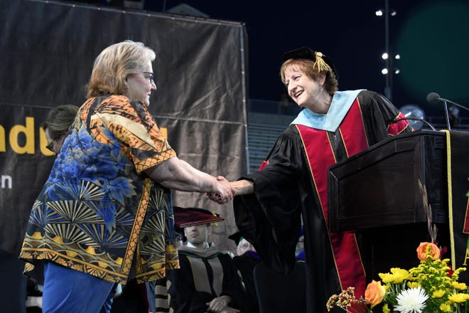 Leslie Bowdoin James accepts an honorary diploma on the behalf of her late sister, Deana Lynne Bowdoin, from Kay Faris, senior associate dean for students of W.P. Carey School of Business at Arizona State University on Tuesday, May 7, 2019.