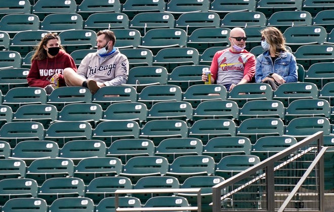 Socially distanced fans watch the Arizona Diamondbacks play the Colorado Rockies during the spring training opener at Salt River Fields at Talking Stick on Feb. 28, 2021, in Scottsdale.