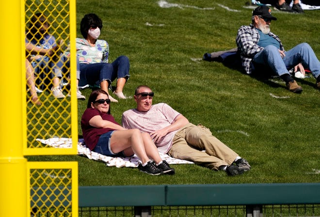Socially distant fans watch the Arizona Diamondbacks play the Colorado Rockies during the spring training opener at Salt River Fields at Talking Stick in Scottsdale, Ariz., on Feb. 28, 2021.