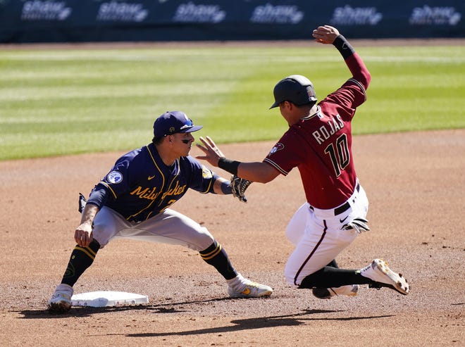 Arizona Diamondbacks Josh Rojas (10) is tagged out by Milwaukee Brewers Luis Ur ’ as (2) at the second base on a pick-off play in the second inning during a spring training game at Salt River Fields at Talking Stick in Scottsdale, Ariz., on March 1, 2021.