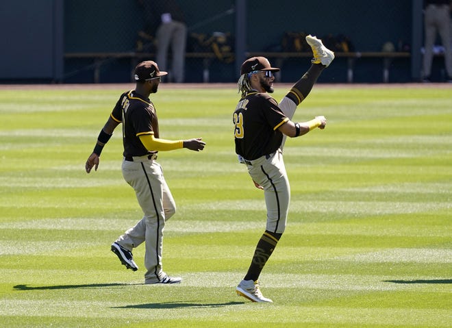 San Diego Padres Fernando Tatis Jr. (right) warms-up before playing the Arizona Diamondbacks during a spring training game at Salt River Fields at Talking Stick in Scottsdale, Ariz., on March 2, 2021.