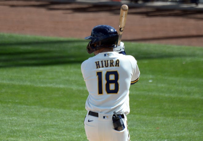 Milwaukee Brewers second baseman Keston Hiura (18) bats against the Cleveland Indians during the first inning of a spring training game at American Family Fields of Phoenix in Ariz., on March 4, 2021.