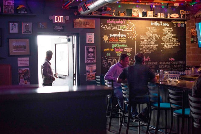 Customers trickle into The Bar in Phoenix hours after Gov. Doug Ducey lifts all COVID-19 restrictions from bars and restaurants on March 25, 2021.