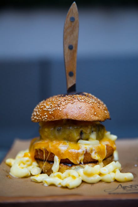 One of The Ainsworth's signature dishes is a burger topped with macaroni and cheese.