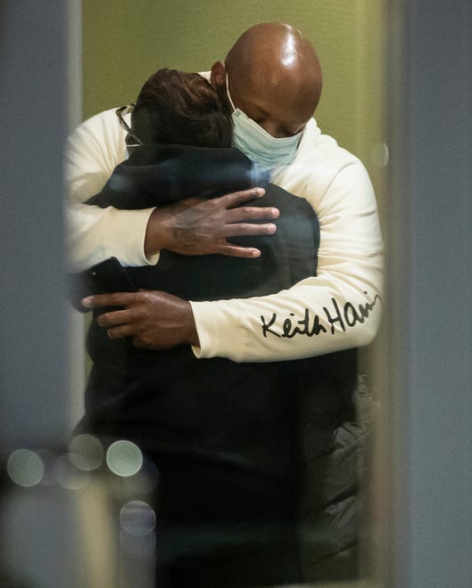 People hug after learning that their loved one is safe after a shooting inside a FedEx building Friday, April 16, 2021. Multiple people were shot and killed in a late-night shooting at a FedEx facility in Indianapolis, and the shooter killed himself, police said.(The Indianapolis Star via AP)