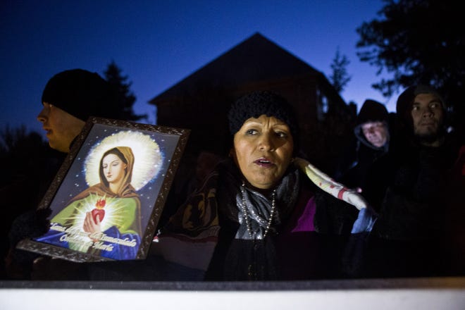Mary Cruz prays outside the Ohio home of Speaker John A. Boehner.