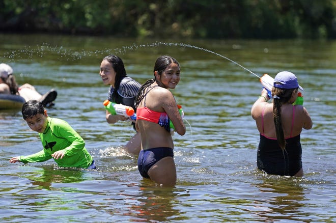 (From left to right) Noah Delgadillo, 9,  Keira, 13, of Surprise and Maya Macias, 12, and Nylah Fontes, 8, of Phoenix, play in the Salt River on May 29, 2021.