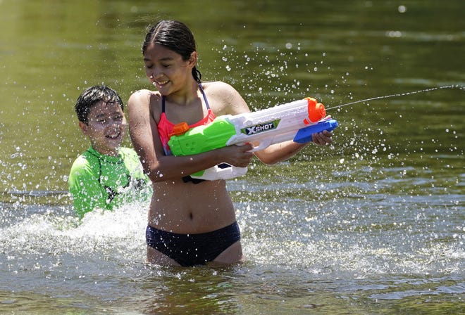 Noah Delgadillo, 9, of Surprise (left) and Maya Macias, 12,  of Phoenix, play in the Salt River on May 29, 2021.