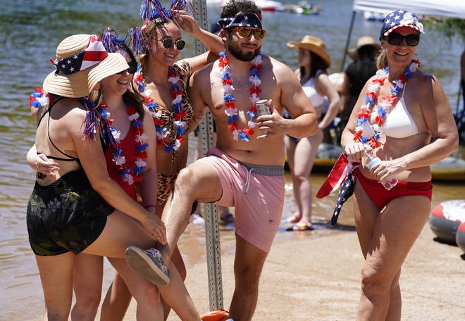 Tubers decked out for Memorial Day pose for a photo at the Salt River on May 29, 2021.