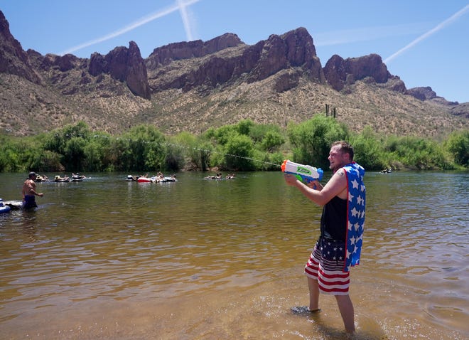 Morgan Ruesga, 24, of Mesa, cools off his friends at the Salt River on May 29, 2021.