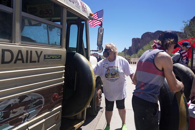 Bus driver Laurie Barnes helps tubers off the bus at the Salt River on May 29, 2021.