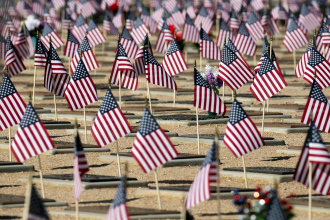 Flags are placed at gravesites on Memorial Day at the National Memorial Cemetery of Arizona in Phoenix on May 31, 2021.
