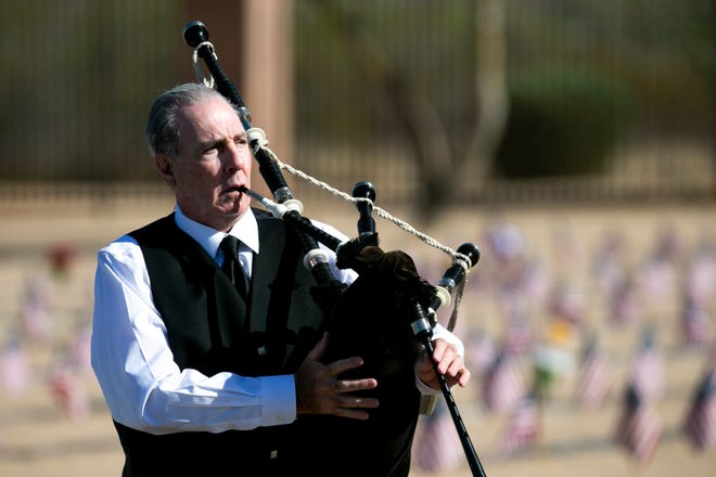 John Mullen plays the bagpipes at the National Memorial Cemetery of Arizona in Phoenix on May 31, 2021.