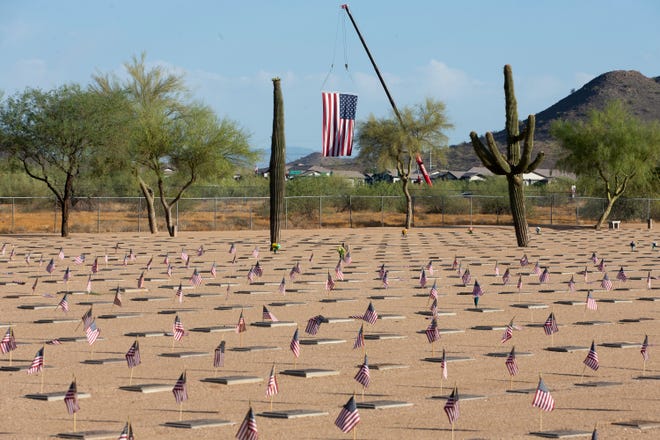 Flags are placed at gravesites on Memorial Day at the National Memorial Cemetery of Arizona in Phoenix on May 31, 2021.