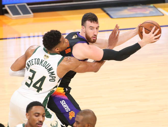 Phoenix Suns forward Frank Kaminsky (8) is fouled by Milwaukee Bucks forward Giannis Antetokounmpo (34) during Game 2 of the NBA Finals at Phoenix Suns Arena July 8, 2021.