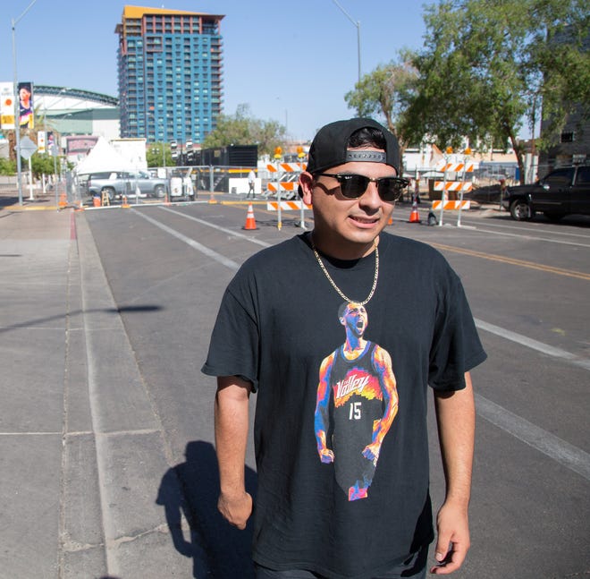 Daniel Garcia wears a shirt of Suns guard Cameron Payne before Game 2 of the NBA Finals near the Phoenix Suns Arena on July 8, 2021.