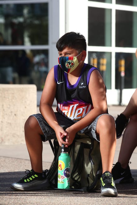 Adrian Guerrero sits outside the Phoenix Suns Arena for Game 2 of the NBA finals vs. the Milwaukee Bucks on July 8, 2021.