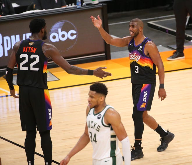 Phoenix Suns guard Chris Paul (3) talks with center Deandre Ayton (22) during Game 2 of the NBA Finals against the Milwaukee Bucks at Phoenix Suns Arena July 8, 2021.
