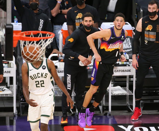 Phoenix Suns guard Devin Booker (1) watches his three point basket go in against the Milwaukee Bucks during Game 2 of the NBA Finals at Phoenix Suns Arena July 8, 2021.