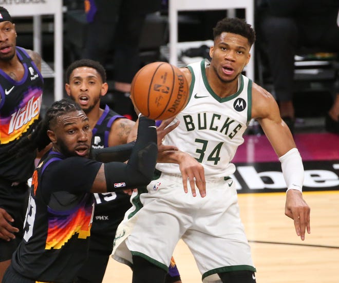 Milwaukee Bucks forward Giannis Antetokounmpo (34) passes the ball against Phoenix Suns forward Jae Crowder (99) during Game 2 of the NBA Finals at Phoenix Suns Arena July 8, 2021.