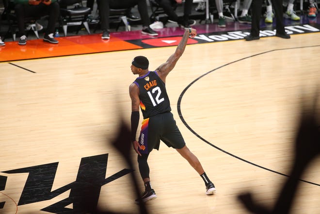 Phoenix Suns forward Torrey Craig (12) hits a three point basket against the Milwaukee Bucks during Game 2 of the NBA Finals at Phoenix Suns Arena July 8, 2021.