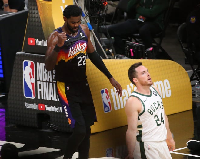 Phoenix Suns center Deandre Ayton (22) pumps his fist after a foul as Milwaukee Bucks guard Pat Connaughton (24) walks away during Game 2 of the NBA Finals at Phoenix Suns Arena July 8, 2021.