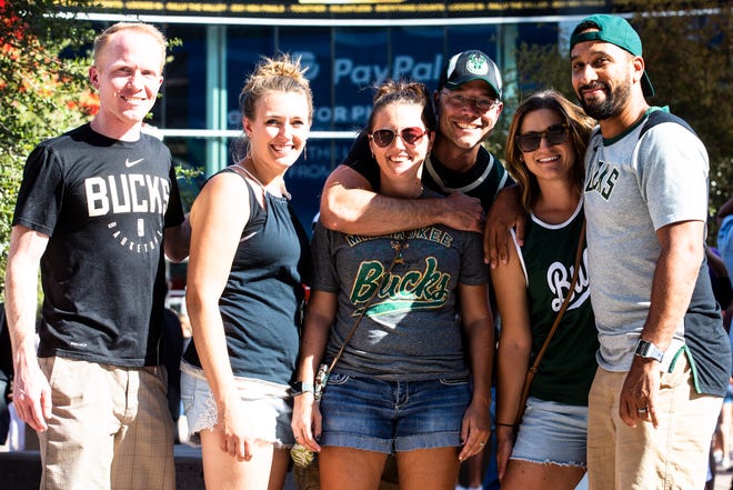 From left, couples and Bucks fans, Joshua and Jamie Schedler, Joshua and Yvonne VanBoxtel and Chris and Elizabeth Walls arrive to the Phoenix Suns Arena for Game 2 of the NBA finals vs. the Milwaukee Bucks on July 8, 2021.