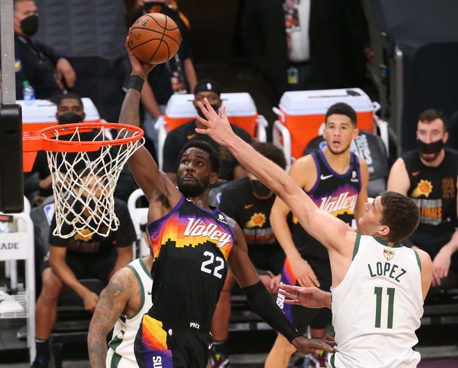 Phoenix Suns center Deandre Ayton (22) goes up against Milwaukee Bucks center Brook Lopez (11) during Game 2 of the NBA Finals at Phoenix Suns Arena July 8, 2021.