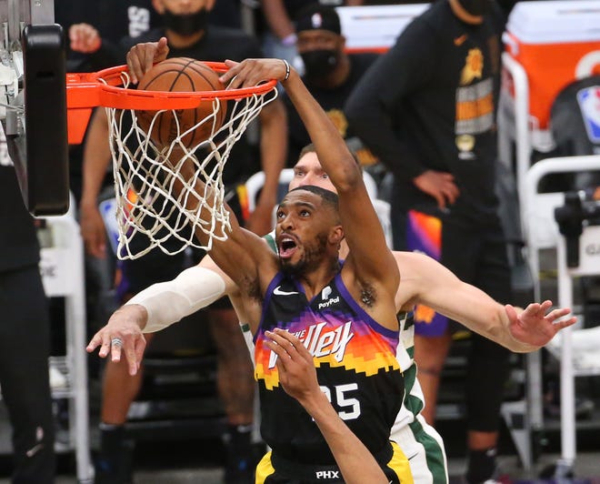 Phoenix Suns forward Mikal Bridges (25) slams two against Milwaukee Bucks center Brook Lopez (11) during Game 2 of the NBA Finals at Phoenix Suns Arena July 8, 2021.