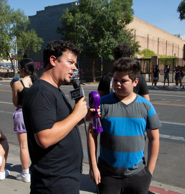 Comedian Michael Turner with Tailgate Trolling interviews Aidan Bedoy, 11, before Game 2 of the NBA Finals near the Phoenix Suns Arena on July 8, 2021.