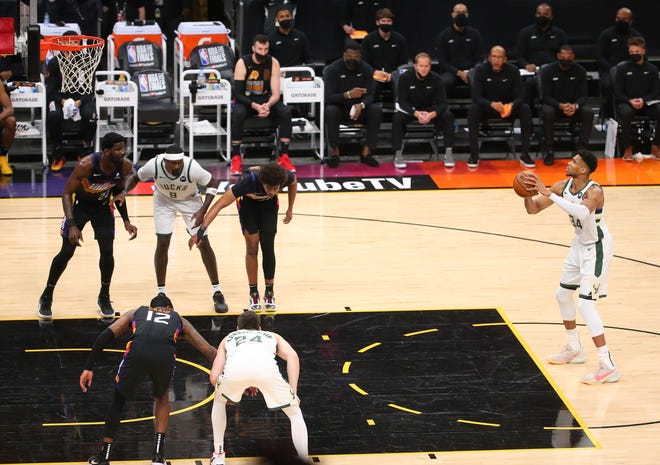 Milwaukee Bucks forward Giannis Antetokounmpo (34) shoots a free throw against the Phoenix Suns during Game 2 of the NBA Finals at Phoenix Suns Arena July 8, 2021.