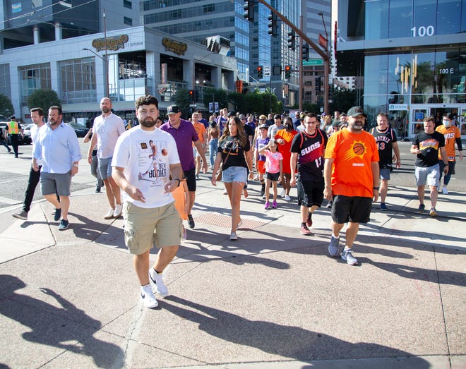 Fans prepare to enter the Phoenix Suns Arena before Game 2 of the NBA Finals on July 6, 2021.