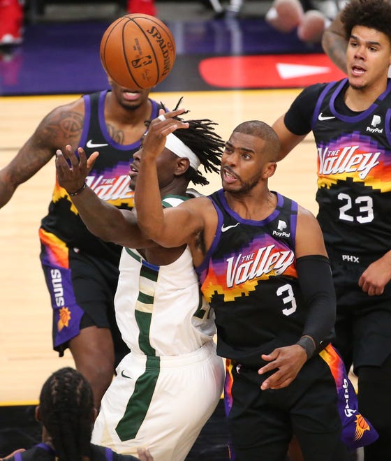Phoenix Suns guard Chris Paul (3) grabs a rebound from Milwaukee Bucks guard Jrue Holiday (21) during Game 2 of the NBA Finals at Phoenix Suns Arena July 8, 2021.