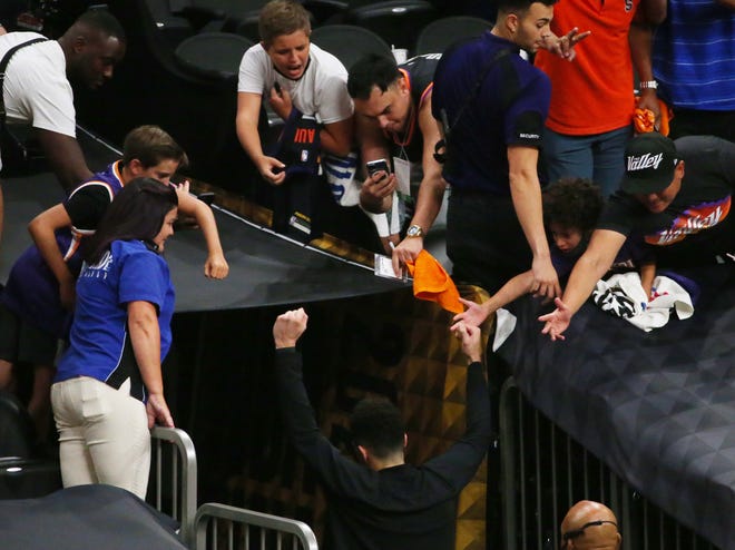 Phoenix Suns guard Devin Booker exits the court after beating the Milwaukee Bucks 118-108 in Game 2 of the NBA Finals at Phoenix Suns Arena July 8, 2021.