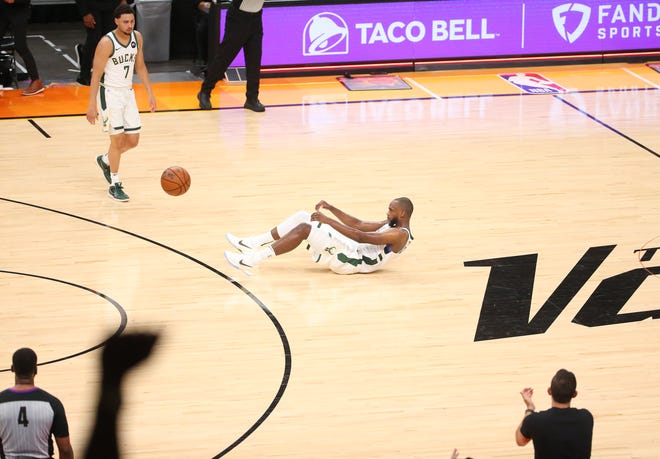 Milwaukee Bucks forward Khris Middleton (22) lays on the ground after a missed shot to end the 2nd quarter against the Phoenix Suns during Game 2 of the NBA Finals at Phoenix Suns Arena July 8, 2021.