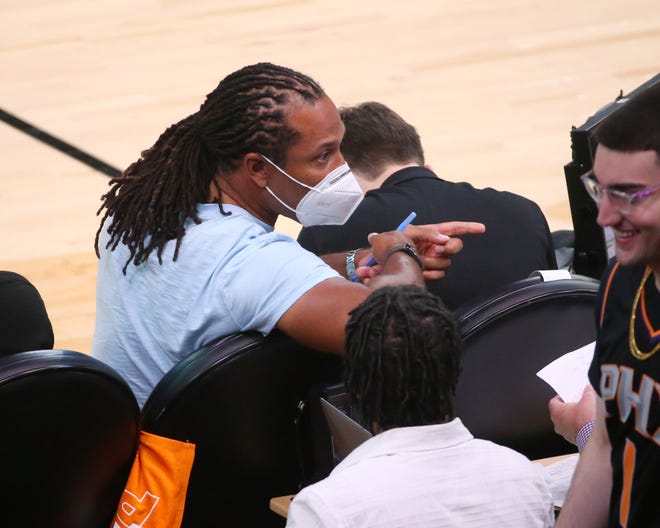 Larry Fitzgerald talks to a fan during Game 2 of the NBA Finals between the Phoenix Suns and the Milwaukee Bucks at Phoenix Suns Arena July 8, 2021.