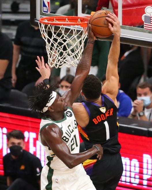 Phoenix Suns guard Devin Booker (1) has his shot blocked by Milwaukee Bucks guard Jrue Holiday (21) during Game 2 of the NBA Finals at Phoenix Suns Arena July 8, 2021.