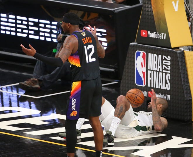 Phoenix Suns forward Torrey Craig (12) reacts to a foul call against Milwaukee Bucks forward P.J. Tucker (17) during Game 2 of the NBA Finals at Phoenix Suns Arena July 8, 2021.