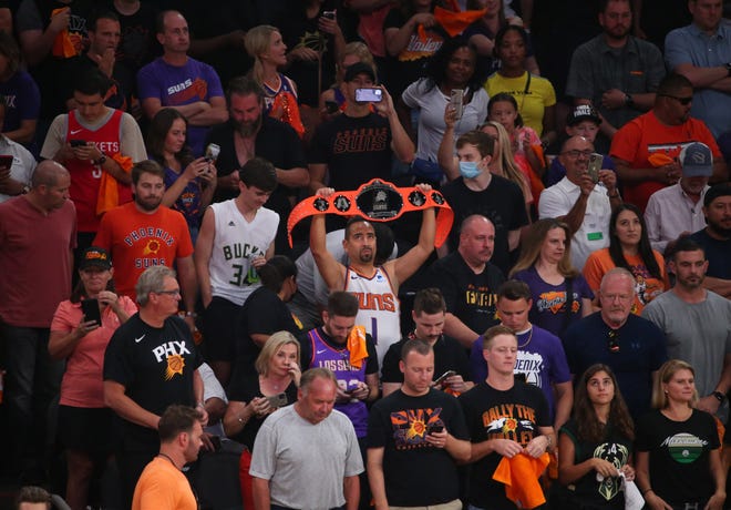 A fan holds a belt for the Phoenix Suns during Game 2 of the NBA Finals against the Milwaukee Bucks at Phoenix Suns Arena July 8, 2021.