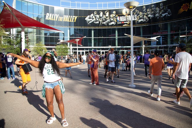 A Milwaukee Bucks fan dances and poses before Game 2 of the NBA Finals outside the Phoenix Suns Arena on July 8, 2021.