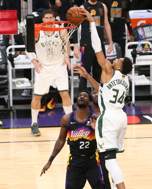 Milwaukee Bucks forward Giannis Antetokounmpo (34) slams tow against Phoenix Suns center Deandre Ayton (22) during Game 2 of the NBA Finals at Phoenix Suns Arena July 8, 2021.