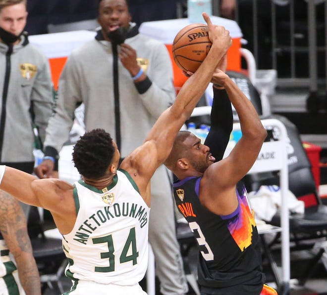 Milwaukee Bucks forward Giannis Antetokounmpo (34) blocks a shot by Phoenix Suns guard Chris Paul (3) during Game 2 of the NBA Finals at Phoenix Suns Arena July 8, 2021.