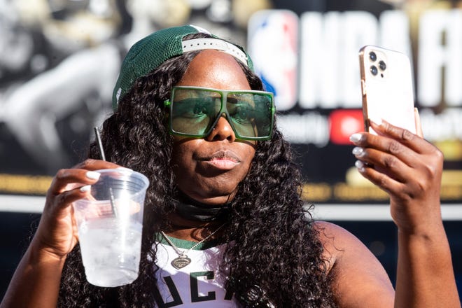Katherine Poston takes a picture at the Phoenix Suns Arena for Game 2 of the NBA finals vs. the Milwaukee Bucks on July 8, 2021.