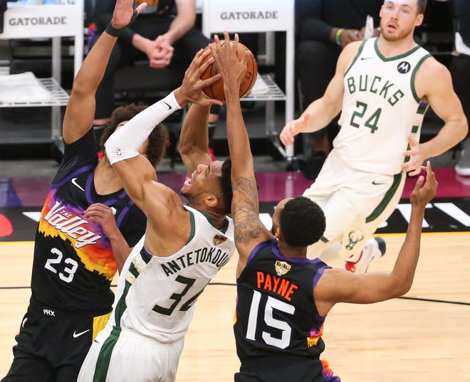 Phoenix Suns guard Cameron Payne (15) knocks the ball away from Milwaukee Bucks forward Giannis Antetokounmpo (34) during Game 2 of the NBA Finals at Phoenix Suns Arena July 8, 2021.
