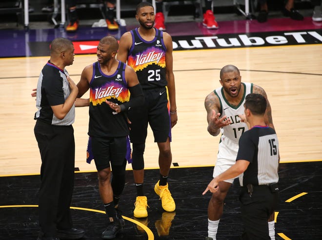 Phoenix Suns guard Chris Paul (3) argues with referee Tony Brothers (25) while Milwaukee Bucks forward P.J. Tucker (17) pleads his case to referee Zach Zarba (15) during Game 2 of the NBA Finals at Phoenix Suns Arena July 8, 2021.