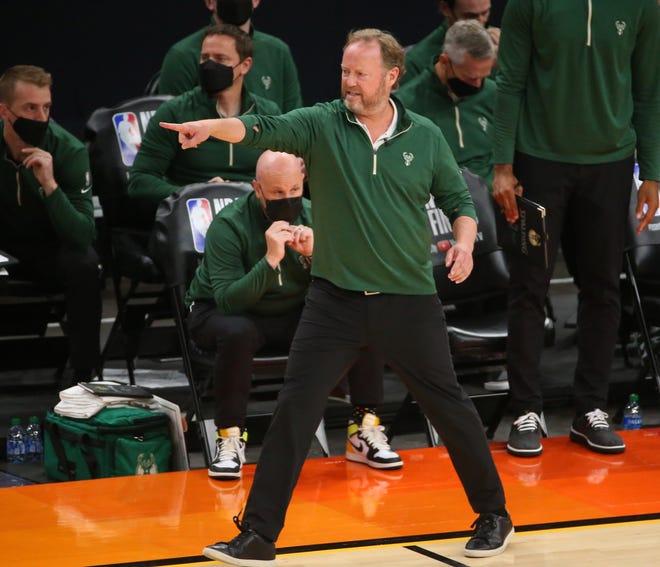 Milwaukee Bucks head coach Mike Budenholzer calls for a timeout against the Phoenix Suns during Game 2 of the NBA Finals at Phoenix Suns Arena July 8, 2021.