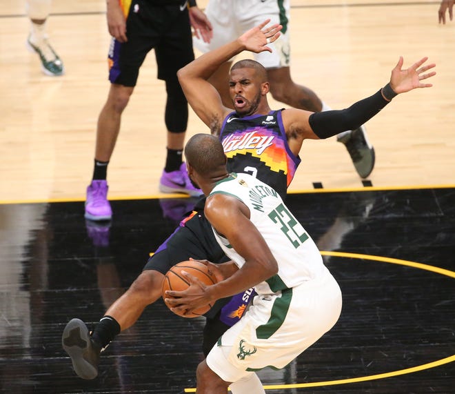 Phoenix Suns guard Chris Paul (3) defends against Milwaukee Bucks forward Khris Middleton (22) during Game 2 of the NBA Finals at Phoenix Suns Arena July 8, 2021.