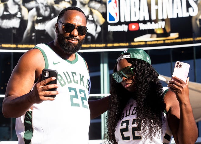 Kenya Seals and Katherine Poston pose at the Phoenix Suns Arena for Game 2 of the NBA finals vs. the Milwaukee Bucks on July 8, 2021.