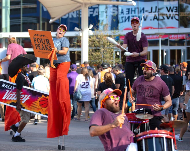 Live performers entertain a crowd before Game 2 of the NBA Finals outside the Phoenix Suns Arena on July 8, 2021.