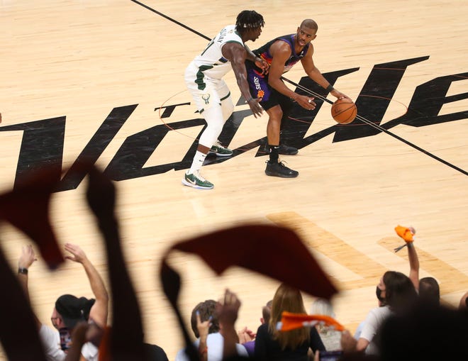 Phoenix Suns guard Chris Paul (3) is defended by Milwaukee Bucks guard Jrue Holiday (21)during Game 2 of the NBA Finals at Phoenix Suns Arena July 8, 2021.